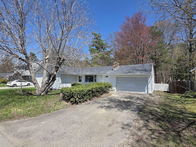 39 Gail St, Winooski, VT 05404 - ranch-style home with a chimney, driveway, a garage, and fence