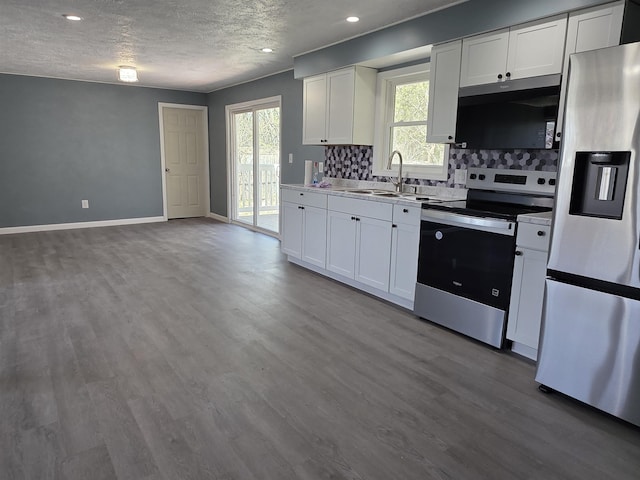 39 Gail St, Winooski, VT 05404 - kitchen featuring stainless steel electric range oven, refrigerator with ice dispenser, a sink, black microwave, and tasteful backsplash