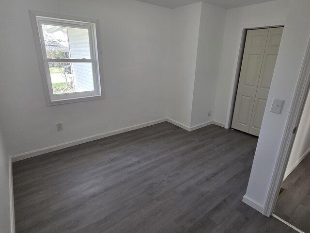 39 Gail St, Winooski, VT 05404 - unfurnished bedroom featuring a closet, dark wood finished floors, and baseboards