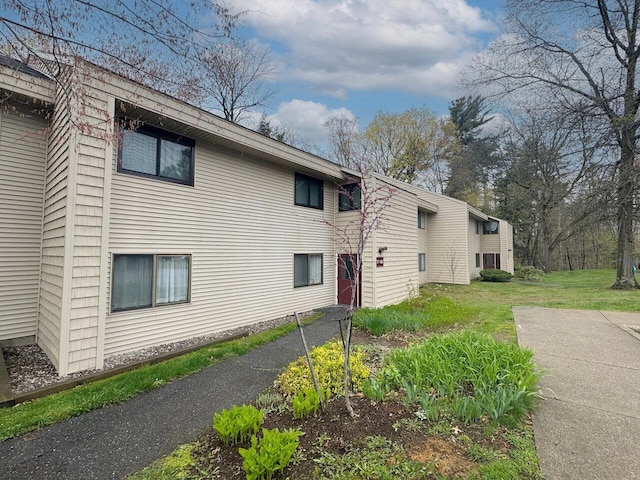 view of side of home featuring a yard