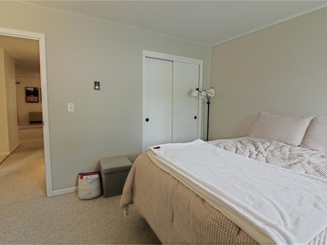 bedroom featuring carpet flooring, a closet, and baseboards