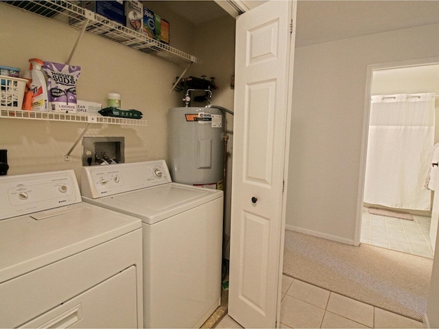 laundry area featuring light colored carpet, water heater, laundry area, separate washer and dryer, and light tile patterned floors