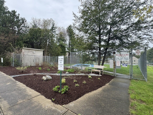view of home's community with fence and a gate