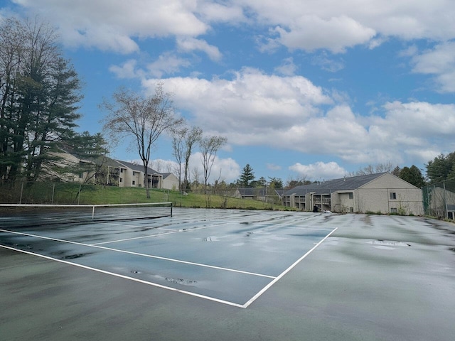view of sport court with fence and a residential view