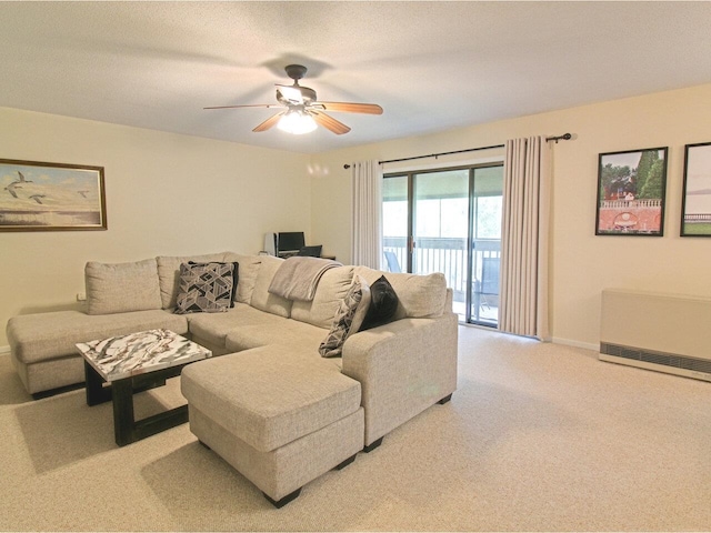 living room featuring ceiling fan, heating unit, carpet flooring, and baseboards
