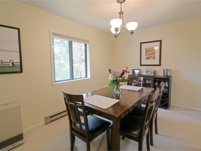 dining space featuring light colored carpet, a baseboard radiator, baseboards, and an inviting chandelier