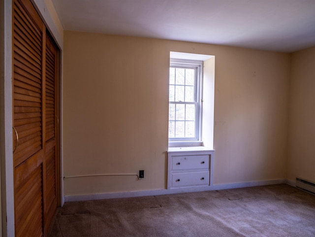 unfurnished room featuring baseboards and carpet