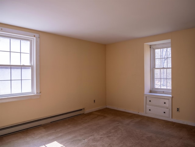 empty room with light carpet, baseboards, and baseboard heating