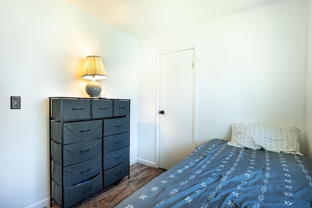 bedroom with wood finished floors and baseboards