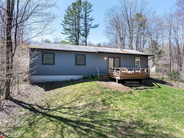 back of property with a yard and a deck