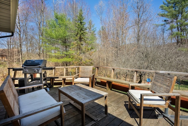 wooden terrace with an outdoor hangout area and area for grilling