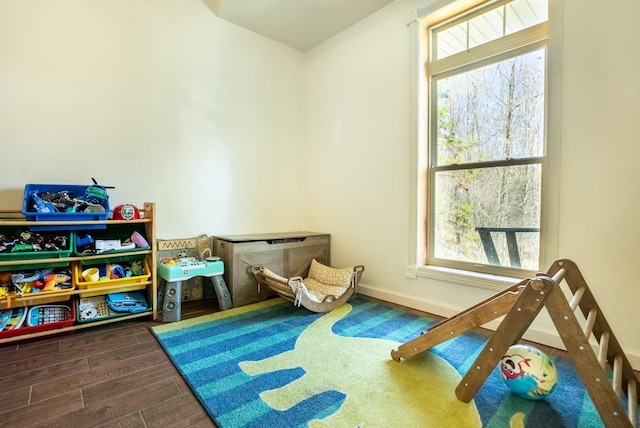 game room with plenty of natural light, wood finished floors, and baseboards