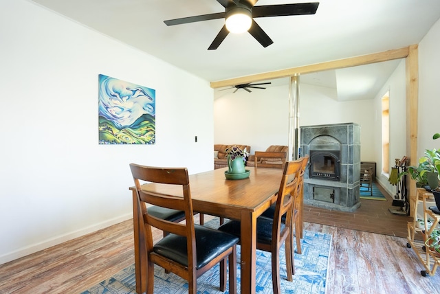 dining area with wood finished floors, baseboards, and ceiling fan