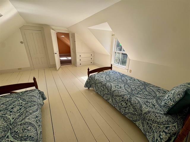 bedroom featuring lofted ceiling and hardwood / wood-style flooring