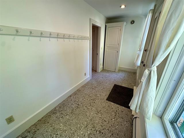hall featuring baseboards