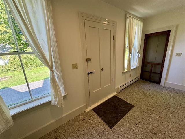 doorway featuring baseboards and baseboard heating