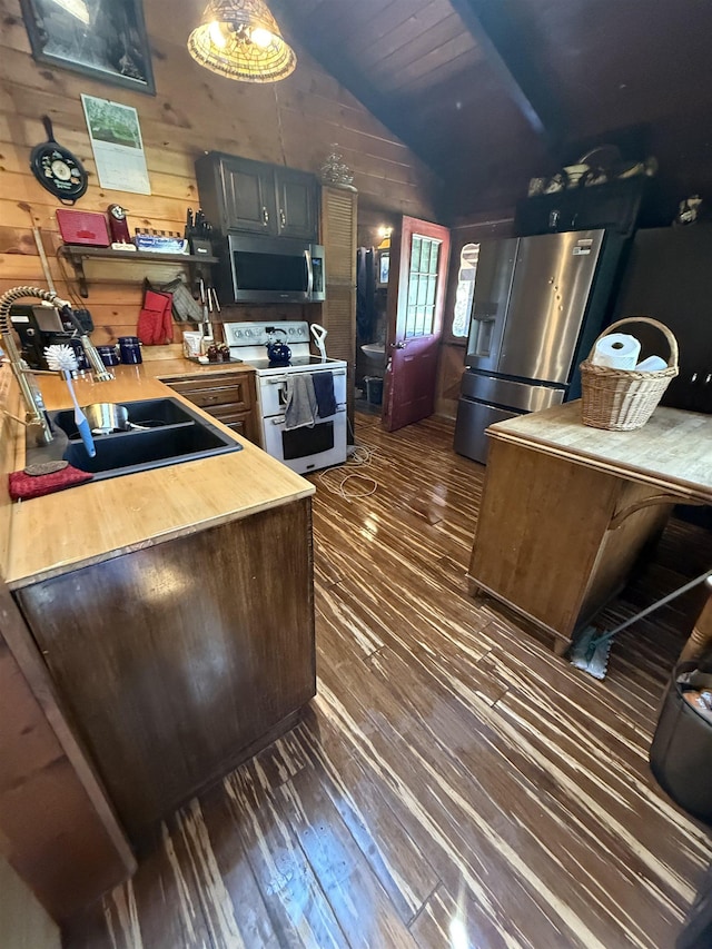 1781 Jersey St S, Addison, VT 05491 - kitchen featuring appliances with stainless steel finishes, dark wood-style flooring, vaulted ceiling, and wood walls