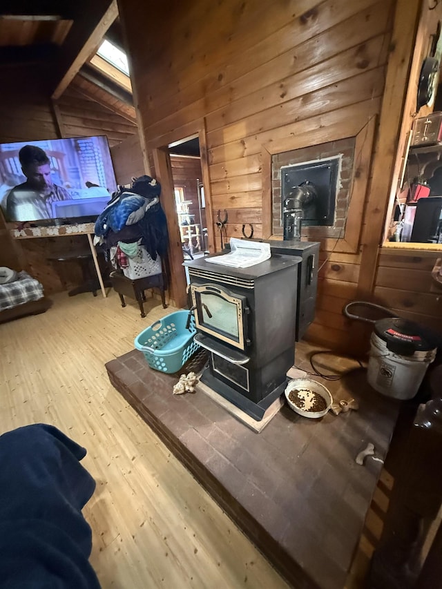 1781 Jersey St S, Addison, VT 05491 - detailed view of a wood stove, wooden walls, wood finished floors, and beamed ceiling