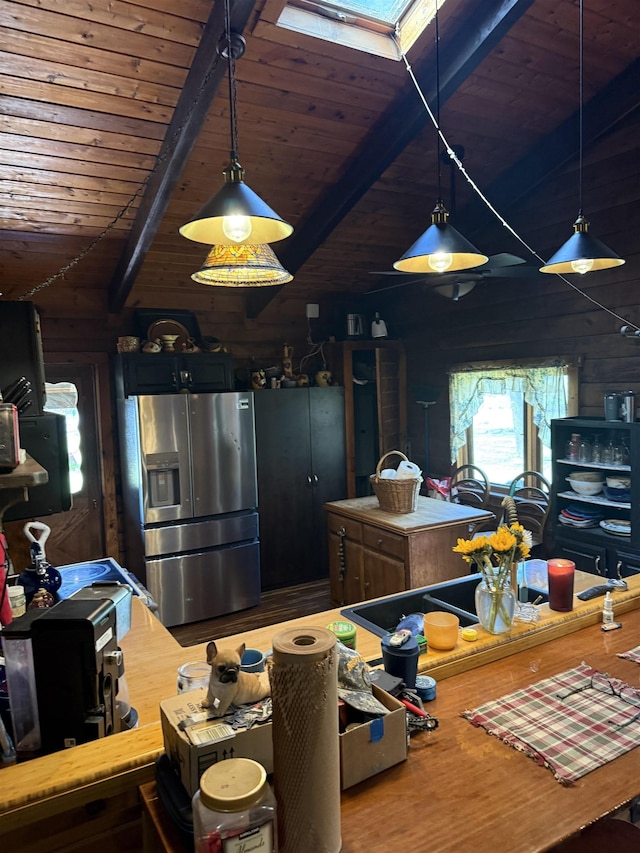 1781 Jersey St S, Addison, VT 05491 - kitchen with stainless steel fridge with ice dispenser, a wood ceiling with exposed beams, wood finished floors, and hanging light fixtures
