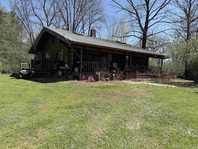 1781 Jersey St S, Addison, VT 05491 - view of front of home featuring a chimney, a front yard, a metal roof, and a porch