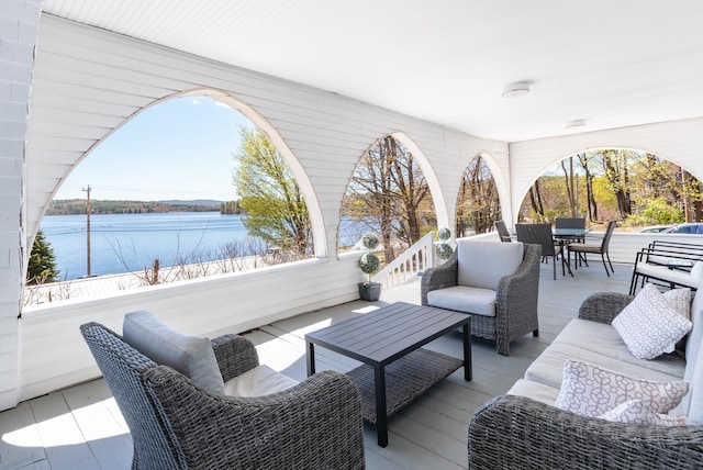 view of patio / terrace with an outdoor living space and a water view