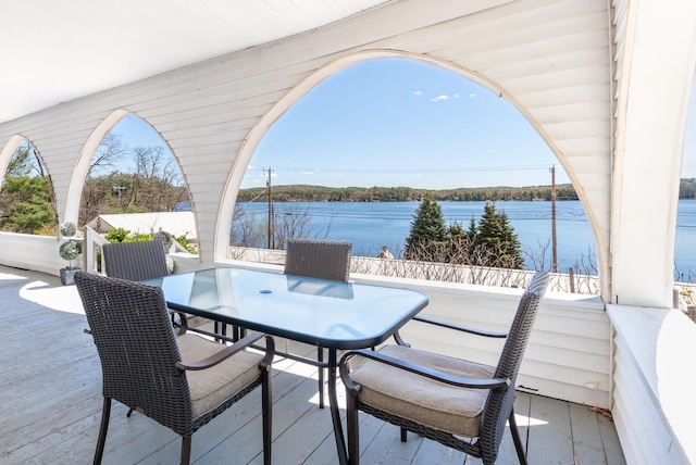 view of patio featuring a water view and outdoor dining area