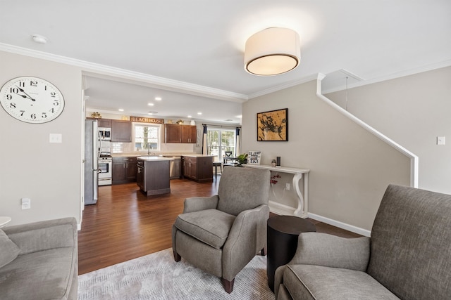 living area featuring ornamental molding, attic access, recessed lighting, and dark wood-type flooring