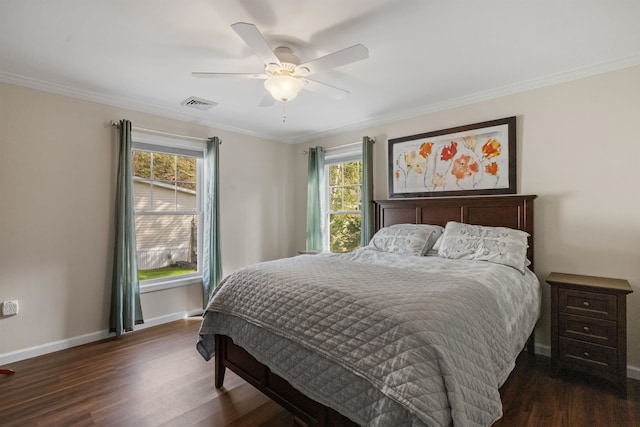 bedroom with dark wood-style floors, visible vents, and multiple windows