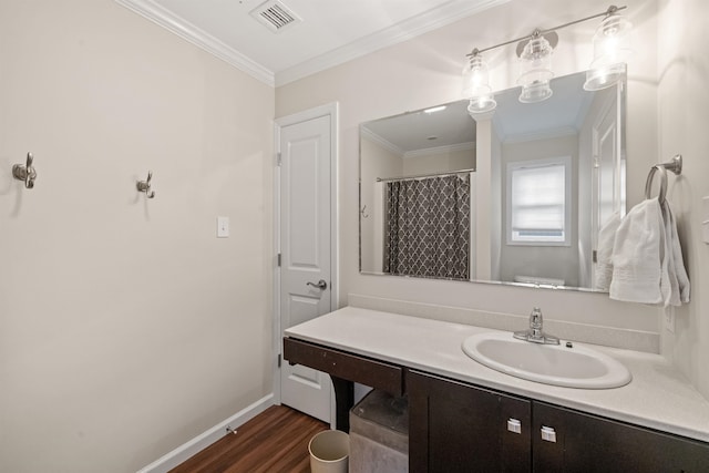 bathroom with wood finished floors, visible vents, baseboards, vanity, and ornamental molding