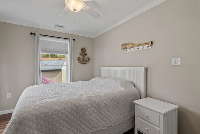 bedroom featuring a ceiling fan, crown molding, dark wood finished floors, visible vents, and baseboards