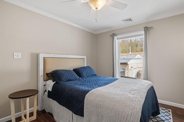 bedroom featuring ornamental molding, dark wood-type flooring, visible vents, a ceiling fan, and baseboards