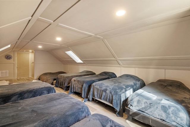 bedroom with lofted ceiling, recessed lighting, and wood finished floors