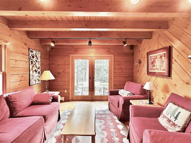 living room featuring french doors, beam ceiling, and wood ceiling