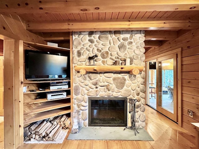 unfurnished living room featuring a fireplace, wood ceiling, beamed ceiling, and wood-type flooring