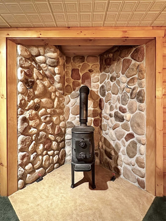 room details with a wood stove, an ornate ceiling, and carpet