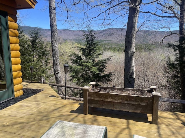 wooden deck featuring a mountain view