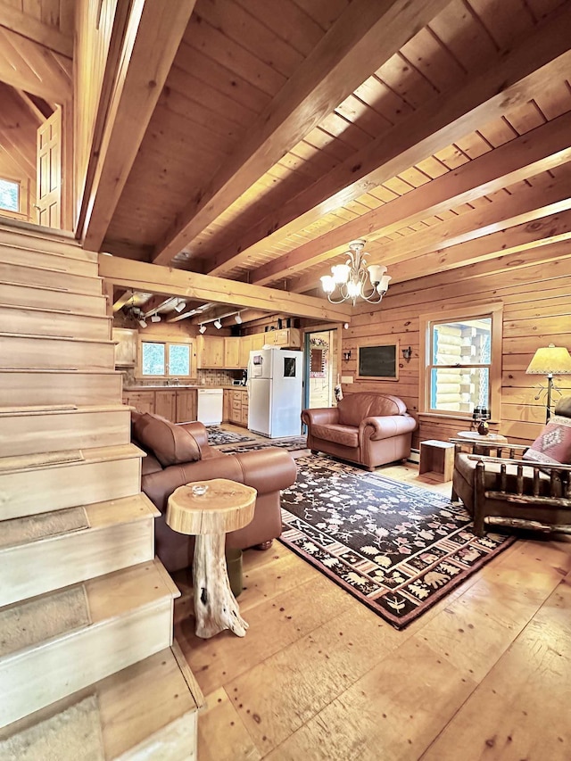 living room with wooden walls, beamed ceiling, wooden ceiling, a chandelier, and hardwood / wood-style flooring
