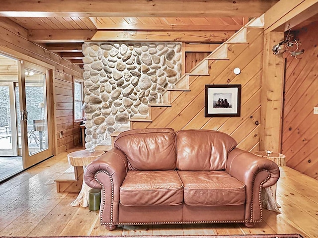 living area featuring wooden ceiling, wood walls, beamed ceiling, and hardwood / wood-style floors