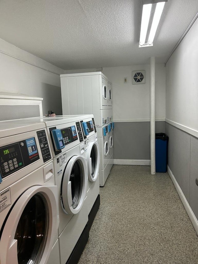 124 Mammoth Rd Unit 206, Hooksett, NH 03106 - shared laundry with stacked washer and clothes dryer, washer and clothes dryer, baseboards, and a textured ceiling