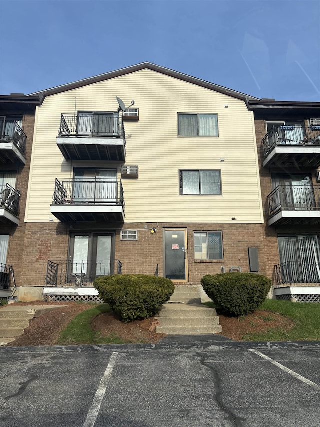 124 Mammoth Rd Unit 206, Hooksett, NH 03106 - view of building exterior featuring uncovered parking