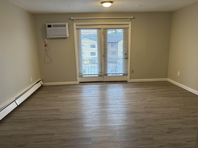 124 Mammoth Rd Unit 206, Hooksett, NH 03106 - unfurnished room featuring a baseboard radiator, wood finished floors, baseboards, and a wall mounted air conditioner