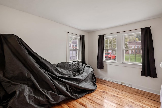 bedroom featuring hardwood / wood-style flooring and baseboards
