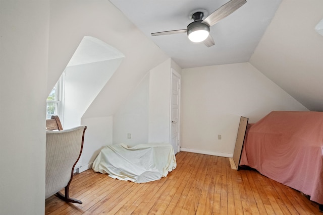 bedroom featuring vaulted ceiling, ceiling fan, baseboards, and light wood-type flooring
