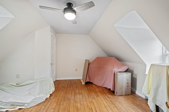additional living space featuring light wood-type flooring, lofted ceiling, and ceiling fan