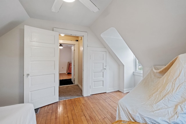 bedroom featuring vaulted ceiling, a ceiling fan, and light wood-style floors