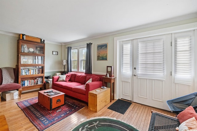 living room with crown molding and hardwood / wood-style floors