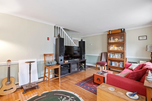 living room with stairway, ornamental molding, wood-type flooring, and baseboards