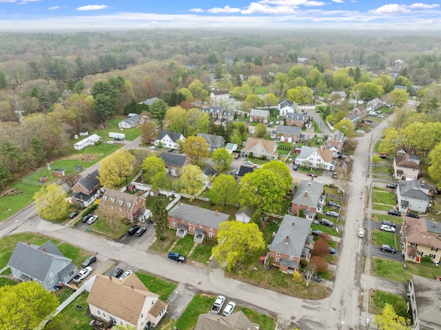 birds eye view of property featuring a wooded view and a residential view