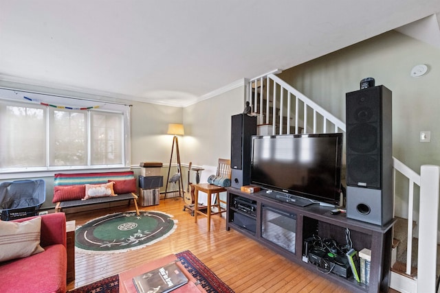 living area with stairway, crown molding, a baseboard radiator, and wood-type flooring
