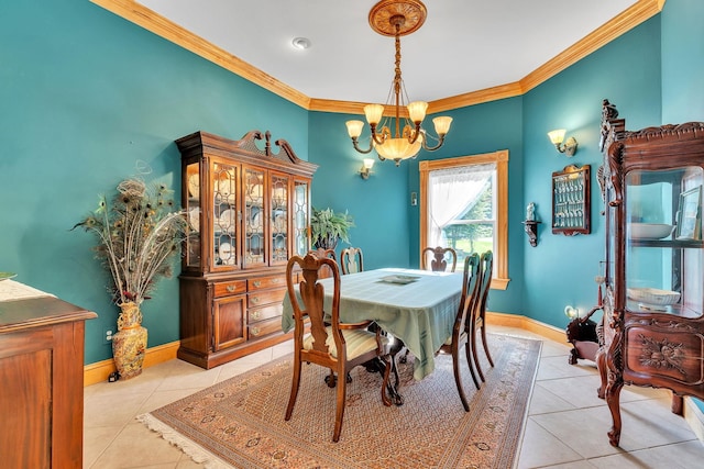 dining area with light tile patterned floors, a notable chandelier, ornamental molding, and baseboards